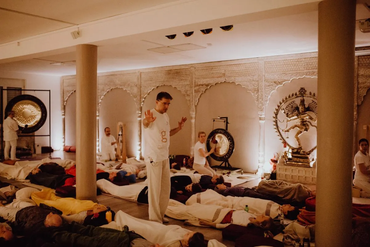 Gruppe von Teilnehmenden bei einer Gong-Session in einem großen Saal